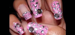 Apply glimmery rhinestones to pink nails