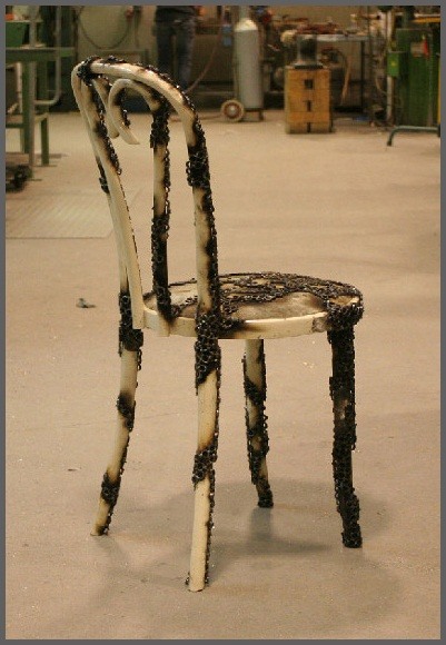 Artist Burns Chairs into Decorative, Fragile Steel Ring Seats with Fire