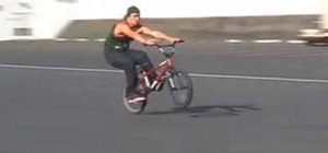 Do a manual to 180 trick on a BMX bicycle