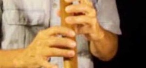 Play music on a wooden, Native American style flute