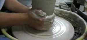 Throw a simple ceramic vase on a pottery wheel